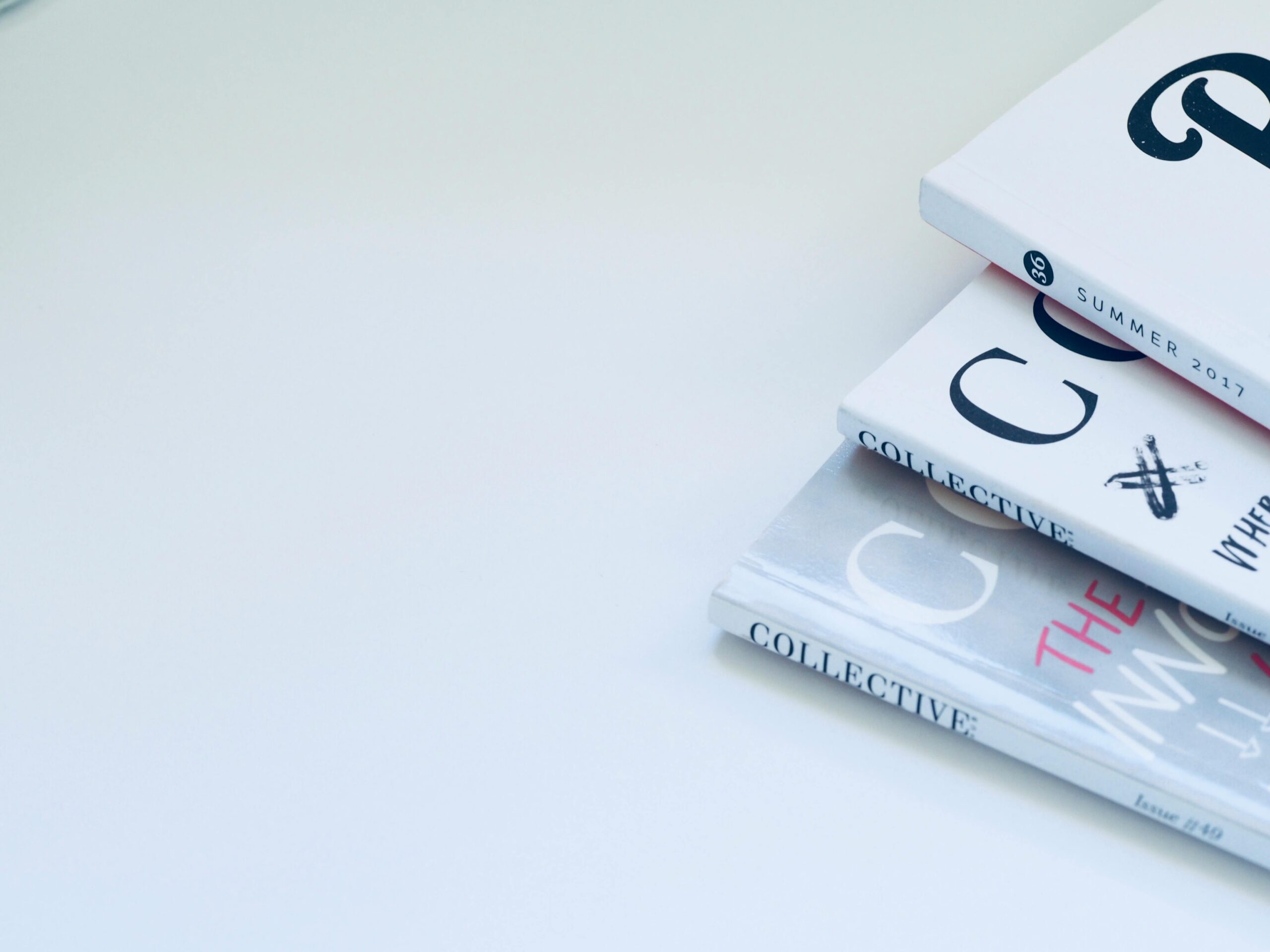 Home Stack of minimalist designed books on a clean white surface, perfect for creative concepts.